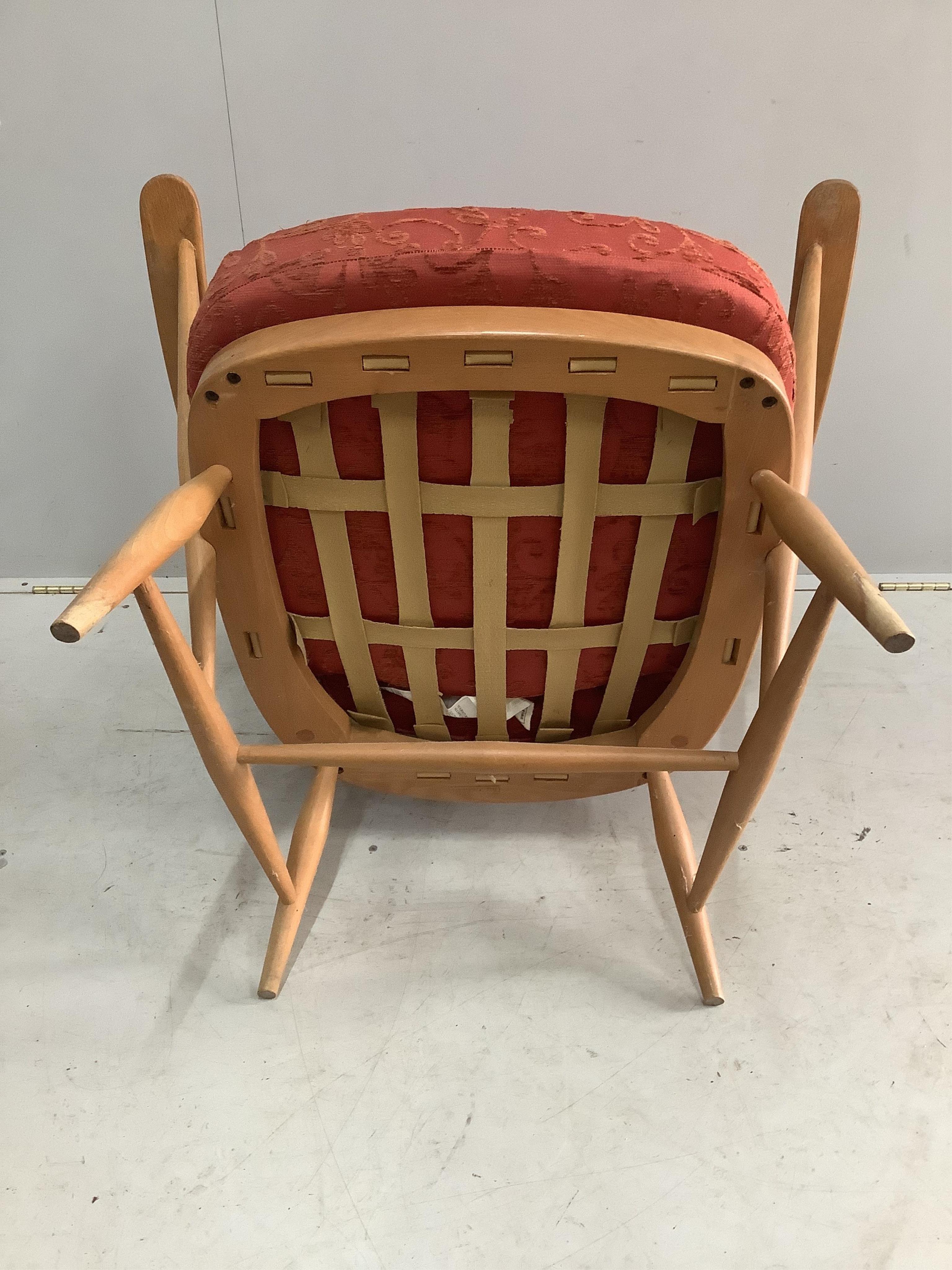 An Ercol golden beech armchair, width 73cm, height 82cm. Condition - rubbing to the tips of the arms, otherwise fair